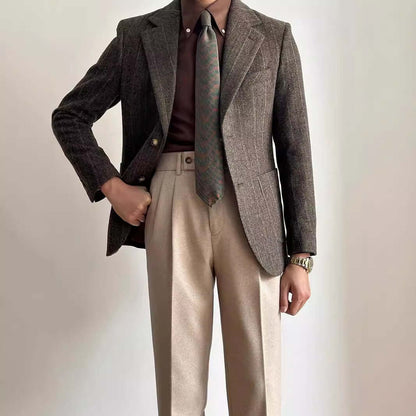 Stylish man wearing tailored suit slacks and blazer, showcasing fashion-forward office and formal event attire.