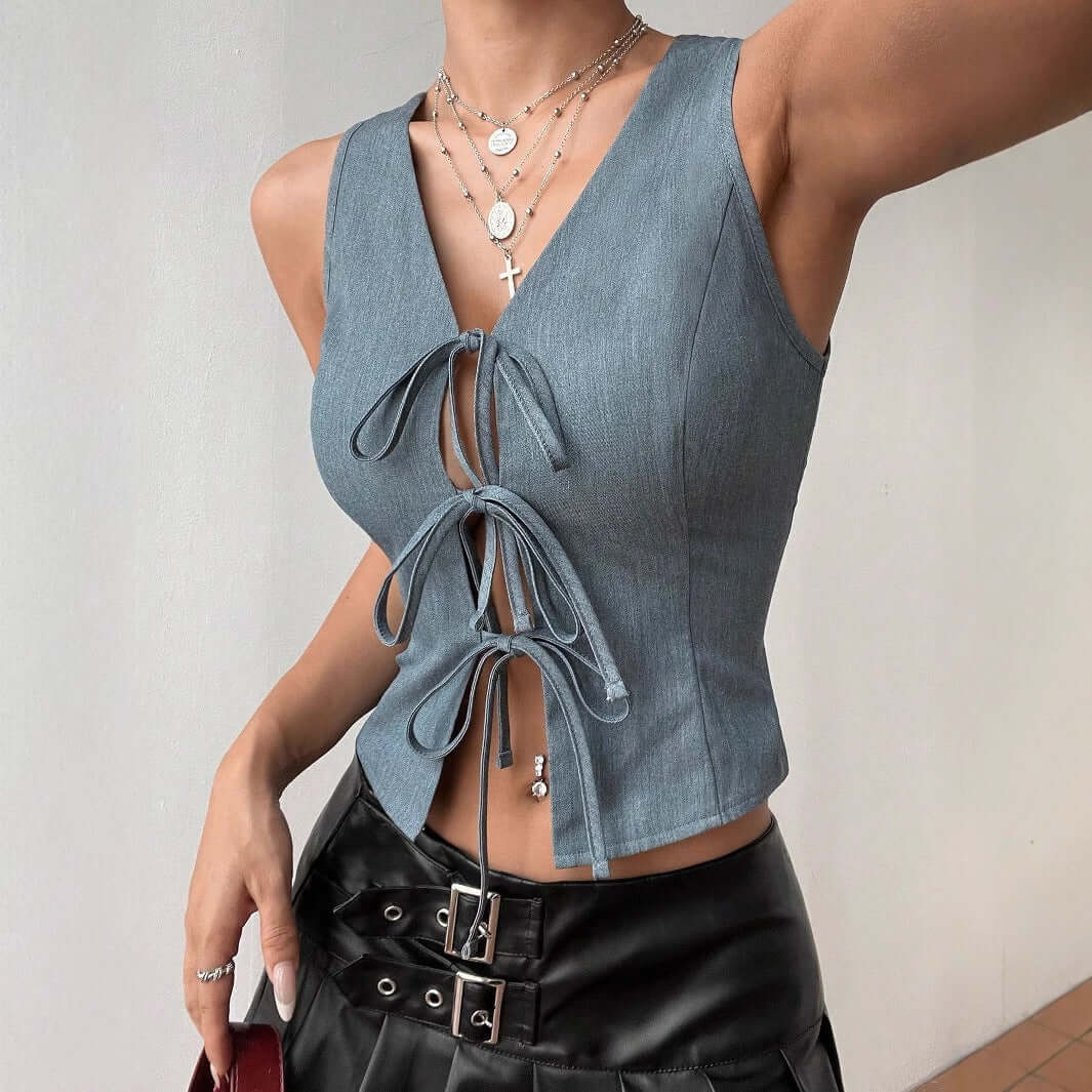 Stylish sleeveless front lace up top in gray, made from soft polyester, featuring a slim fit design, worn with layered necklaces.