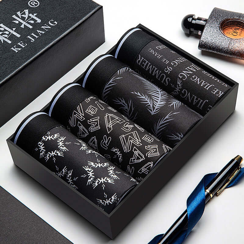 Trendy Men Underwear Pack featuring four stylish, plain-patterned boxer briefs in a sleek black box, ideal for the fashion-forward man.