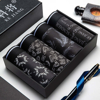 Trendy Men Underwear Pack featuring four stylish, plain-patterned boxer briefs in a sleek black box, ideal for the fashion-forward man.