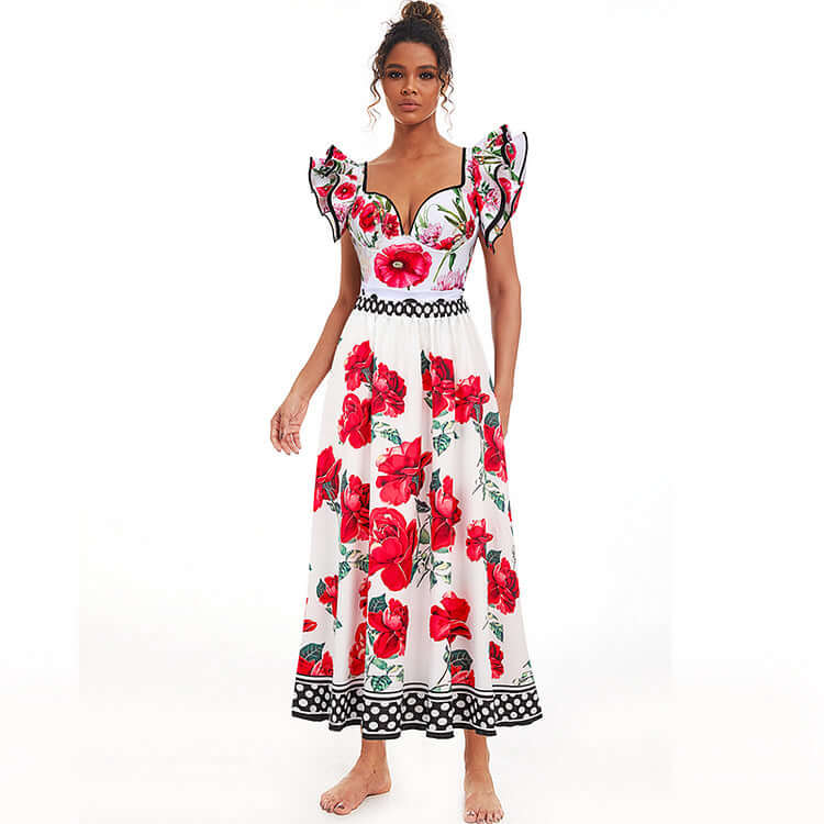 Woman in floral maxi dress with red and black accents, featuring a fitted bodice and full skirt, perfect for a summer look.