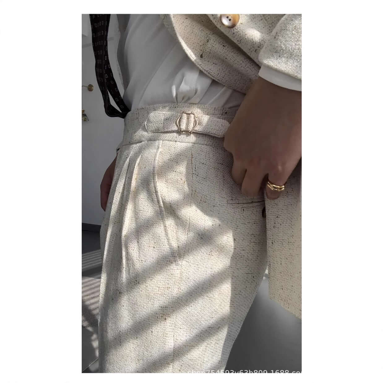 Woman in stylish straight legged trousers and jacket, showcasing detailed design and fit. Perfect blend of comfort and fashion.