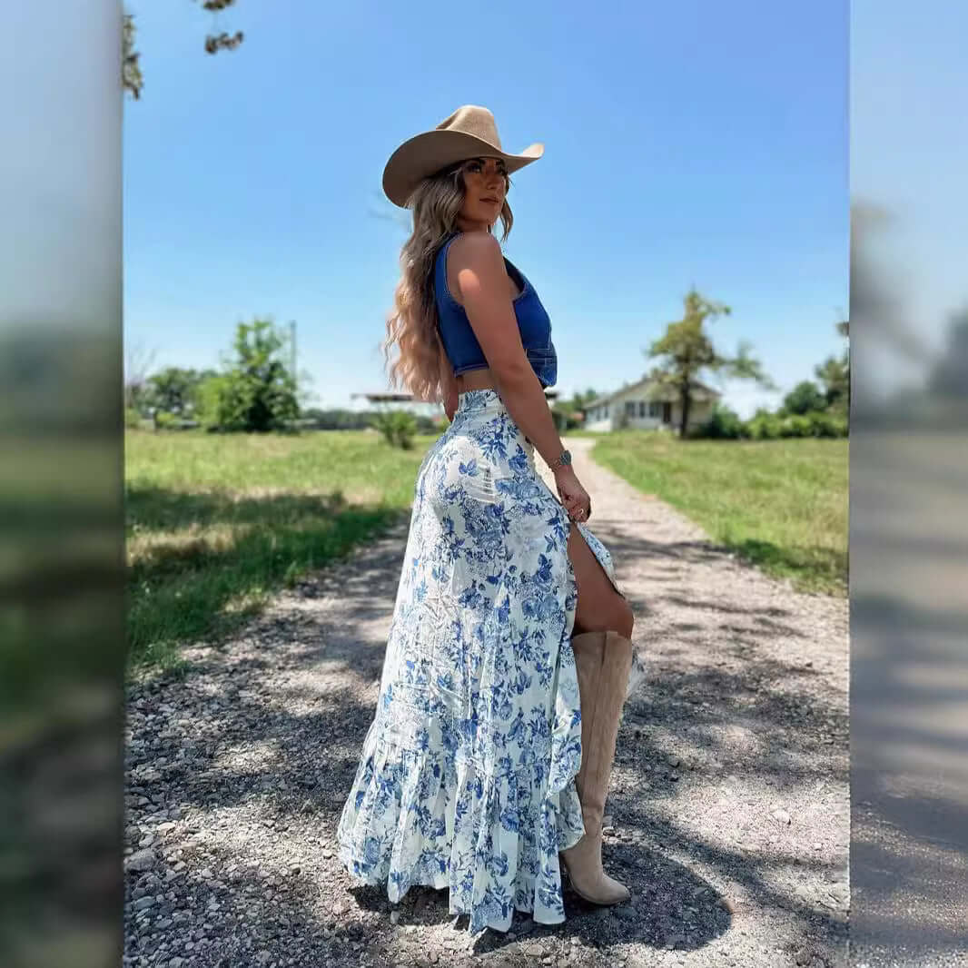 Woman wearing a floral skirt with a cowboy hat in a rural setting, showcasing vibrant flower print and 3D pattern design.