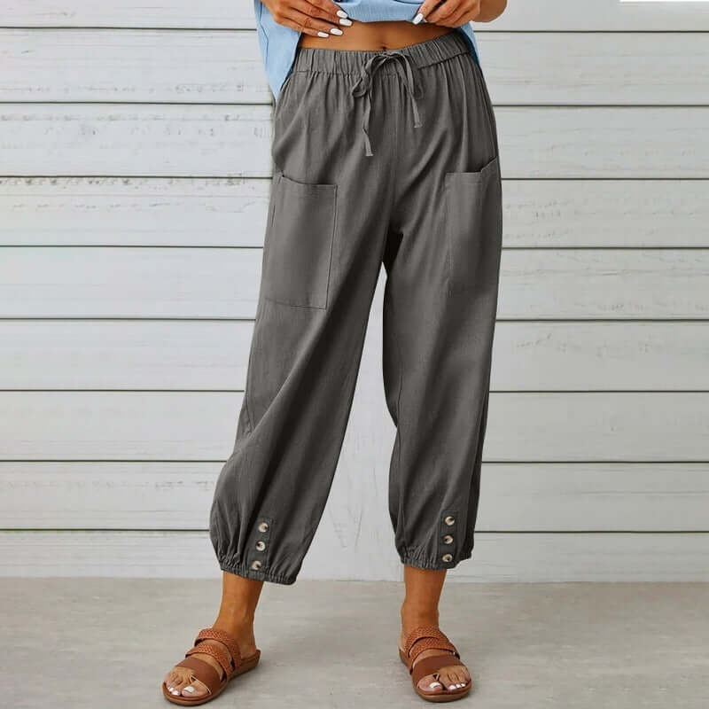 Woman wearing gray ladies linen trousers with pockets, showcasing breathable cotton-linen blend for comfort and style.