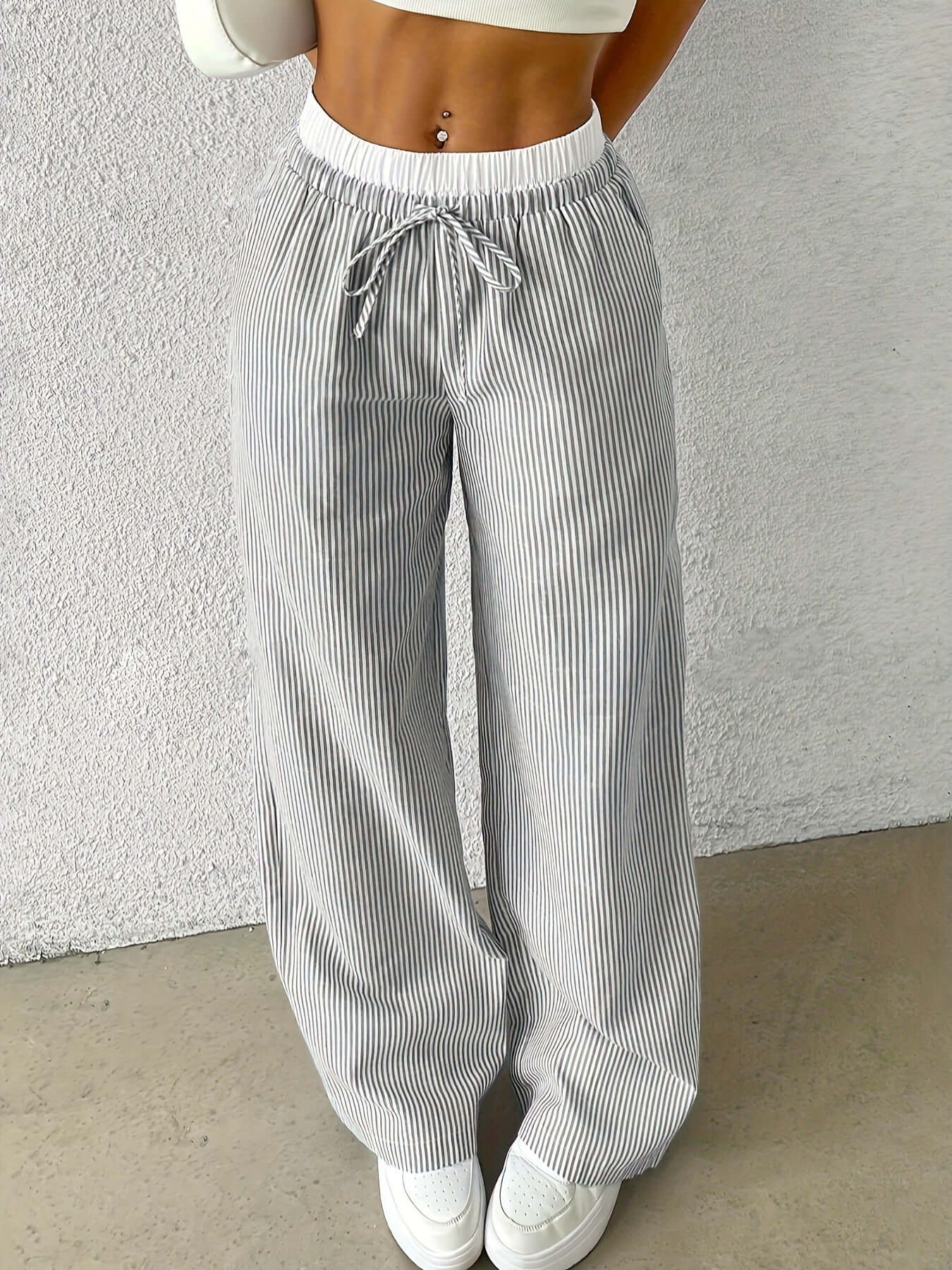 Women's gray stripe trousers with drawstring waist, showcasing a stylish and comfortable fit.