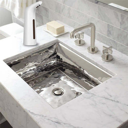 Automatic Liquid Dispenser positioned next to a modern stainless steel sink with marble countertop.