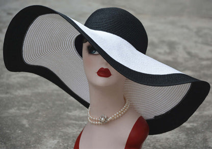 Elegant big straw hat featuring a wide brim in black and white, perfect for sun protection and stylish outdoor occasions.