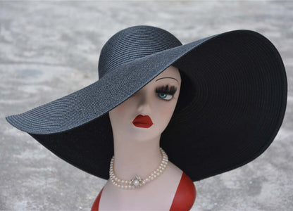 Elegant big straw hat displayed on a mannequin, showcasing sun protection and stylish summer flair.