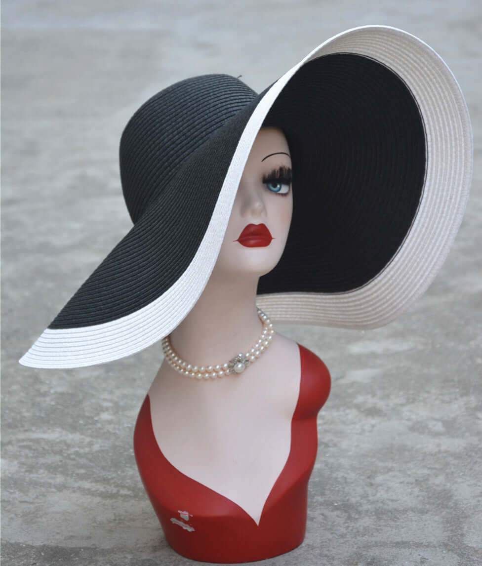 Stylish big straw hat displayed on a mannequin, perfect for sun protection and fashionable summer outings.