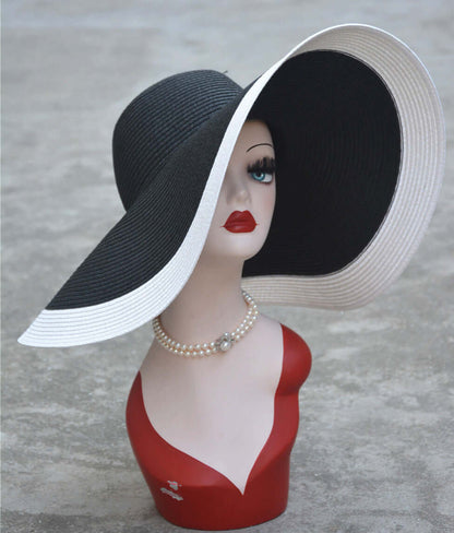 Stylish big straw hat displayed on a mannequin, perfect for sun protection and fashionable summer outings.