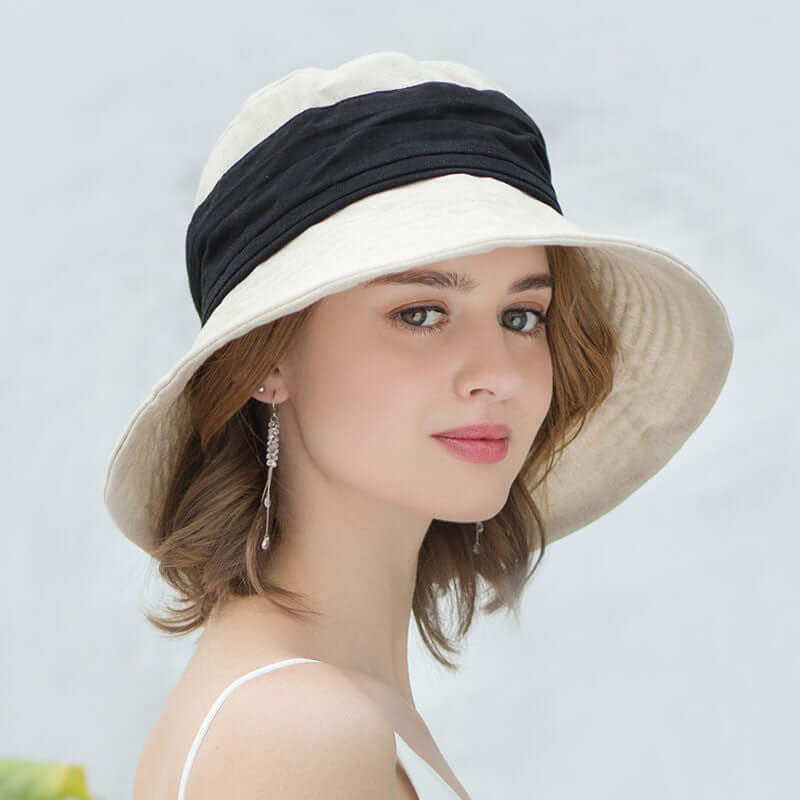 Stylish Bucket Cap Hat in cream and black, perfect for sun protection and fashionable adventures.