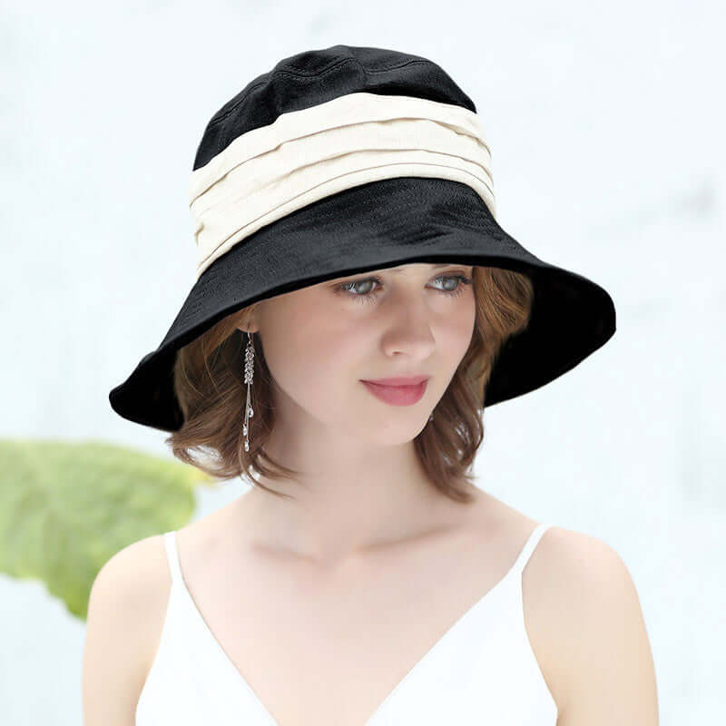Stylish Bucket Cap Hat in black with cream bands, perfect for sun protection and fashion-forward adventures.