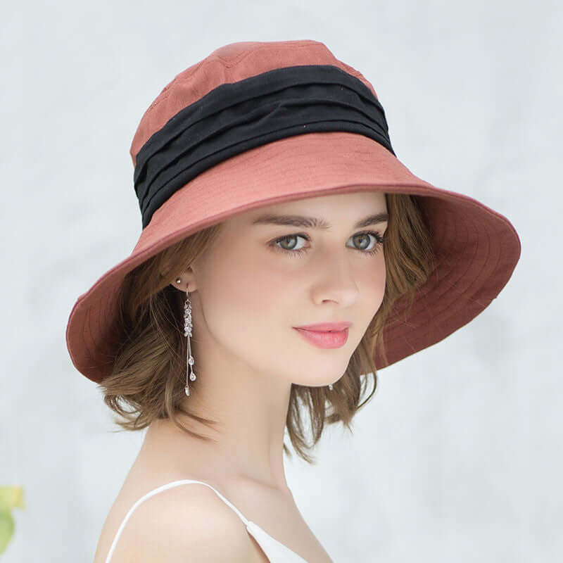 Woman wearing a stylish Bucket Cap Hat with a wide brim and black accents for sun protection.