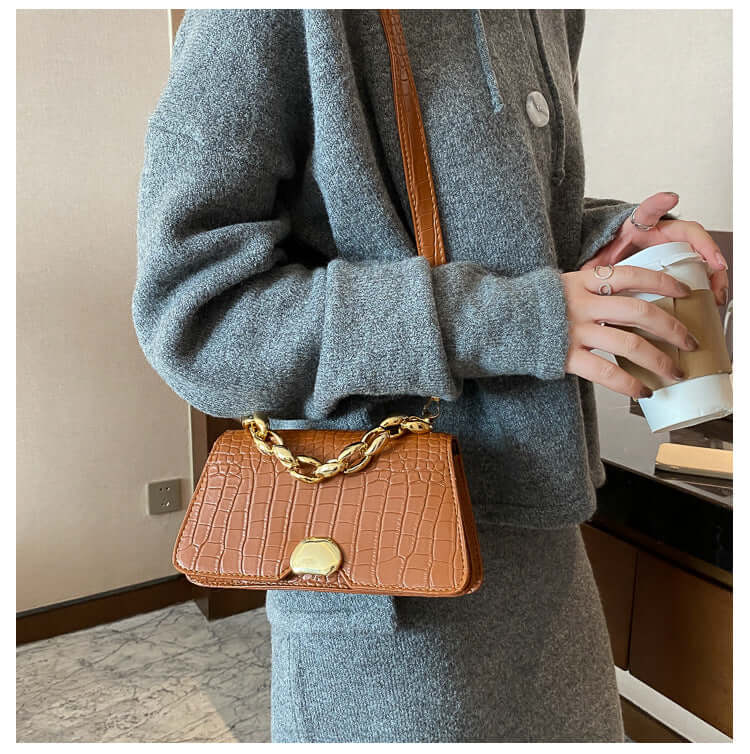 Stylish Crossbody Messenger Bag Purse with chain detail in light brown, perfect for ladies on the go, displayed on a woman's shoulder.
