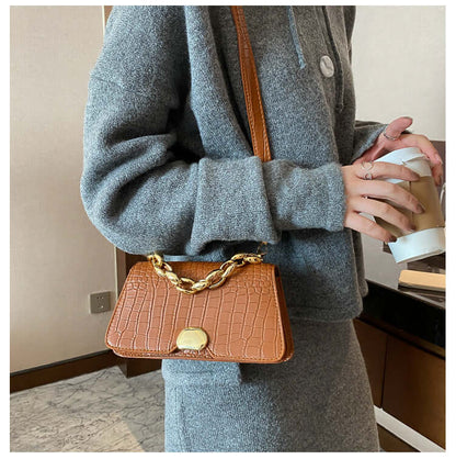 Stylish Crossbody Messenger Bag Purse with chain detail in light brown, perfect for ladies on the go, displayed on a woman's shoulder.