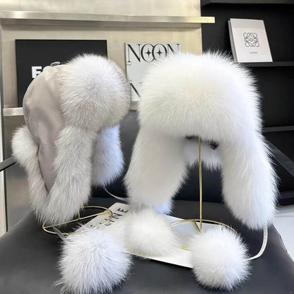 Elegant Ushanka Fur Hats displayed on a stand, showcasing their luxurious white fur and stylish design for winter fashion.