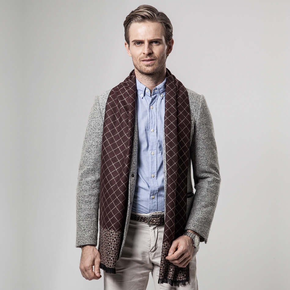 Man wearing a stylish Classic Plaid Warm Scarf in brown, pairing elegance and warmth for the perfect winter fashion statement.
