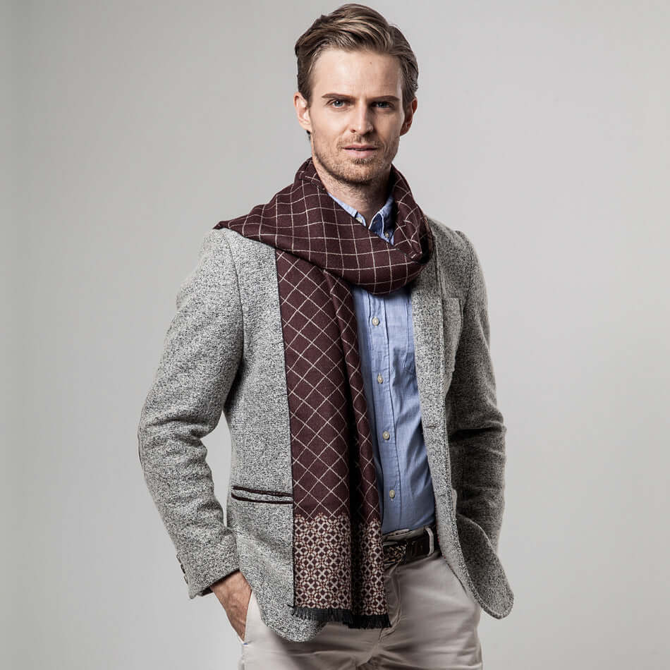 Man wearing a stylish Classic Plaid Warm Scarf over a gray blazer, embodying cozy and fashionable winter style.