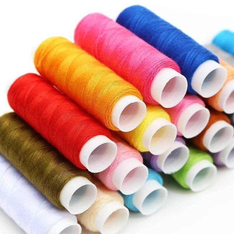 Colorful spools of thread in various hues, essential for your Home Sewing Kit projects and creative crafting.