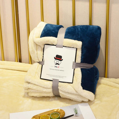 Flannel Plush Blanket folded and presented on a couch, showcasing its cozy, stylish design.