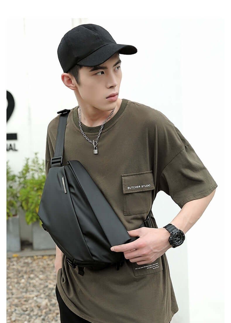 Man wearing Crossbody Multifunctional Bag in Charcoal Black for stylish everyday wear.