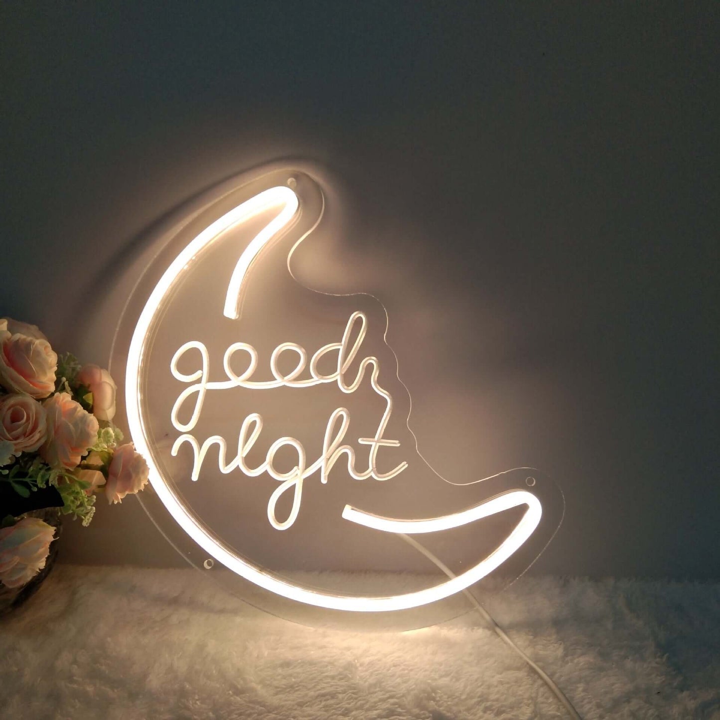Illuminated decorative night light in crescent moon shape with 'good night' text, enhancing home decor.