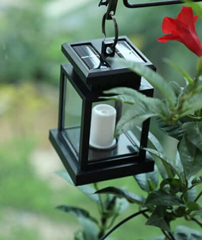 Wind Up Lantern hanging in a garden, showcasing eco-friendly design and durability for outdoor use.