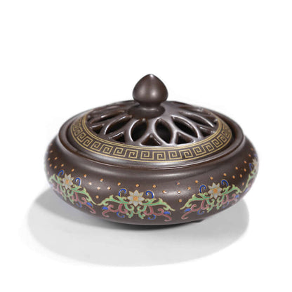 Elegant ceramic incense burner featuring intricate floral designs and a vented lid for enhanced functionality.