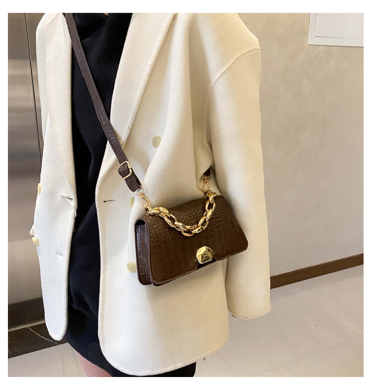 Stylish Crossbody Messenger Bag Purse in dark brown with gold chain and PU leather design, worn by a person in a light coat.