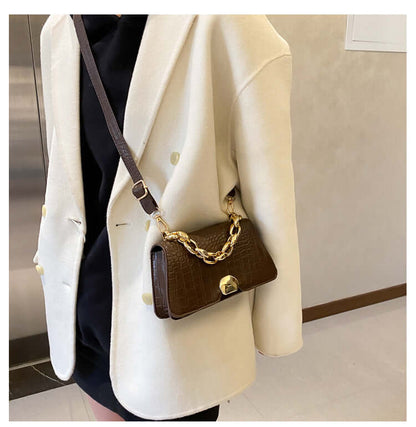 Stylish Crossbody Messenger Bag Purse in dark brown with gold chain and PU leather design, worn by a person in a light coat.