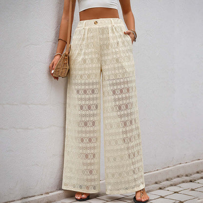 Woman wearing apricot lace wide leg trousers with high waist design, styled with a crop top and wicker handbag for a chic look.