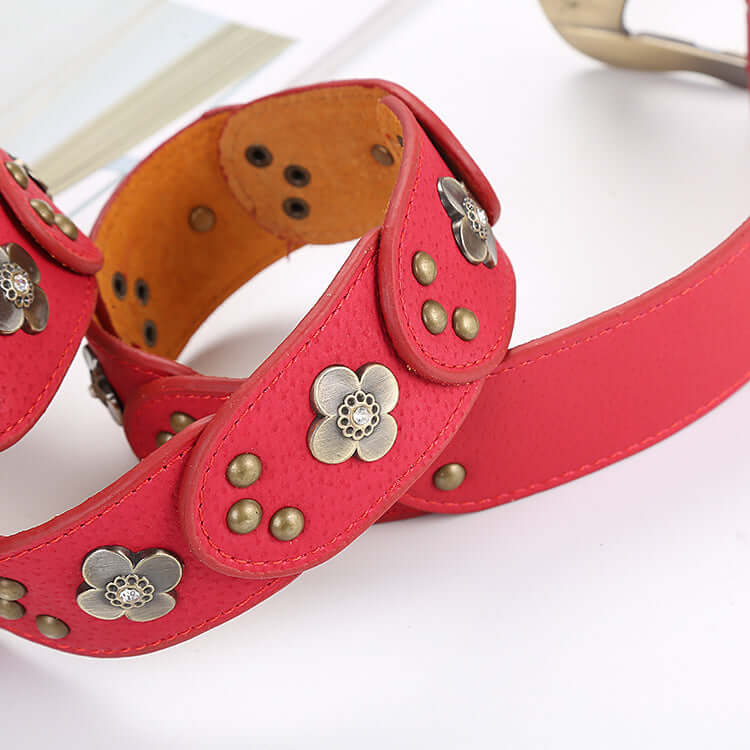 Stylish red Leather Floral Belt featuring intricate flower designs and metallic accents, perfect for any outfit.