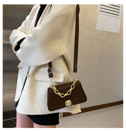 Woman wearing elegant dark brown Crossbody Messenger Bag Purse with chain detail, perfect for stylish on-the-go use.