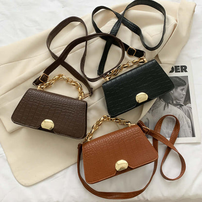 Chic crossbody messenger bag purses in black, dark brown, and light brown with gold chain accents on a white background.