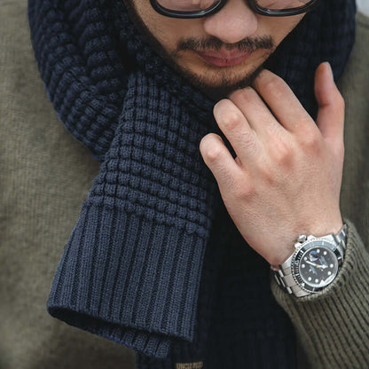 Man wearing navy wool knitted scarf and stylish watch, highlighting winter fashion accessory
