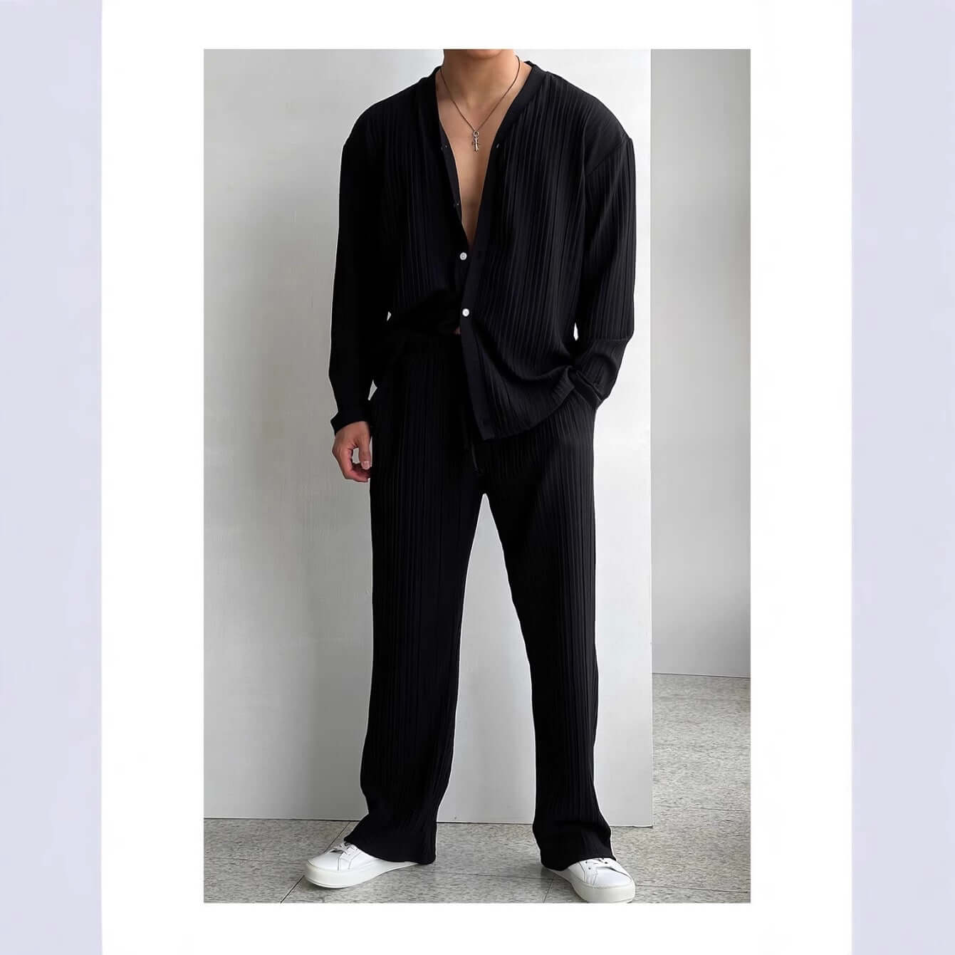 Stylish black loungewear outfit featuring a loose-fitting top and pants, perfect for comfort and relaxation.