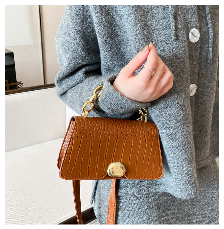 Stylish crossbody messenger bag purse in light brown with chain strap, perfect for chic and durable on-the-go fashion.