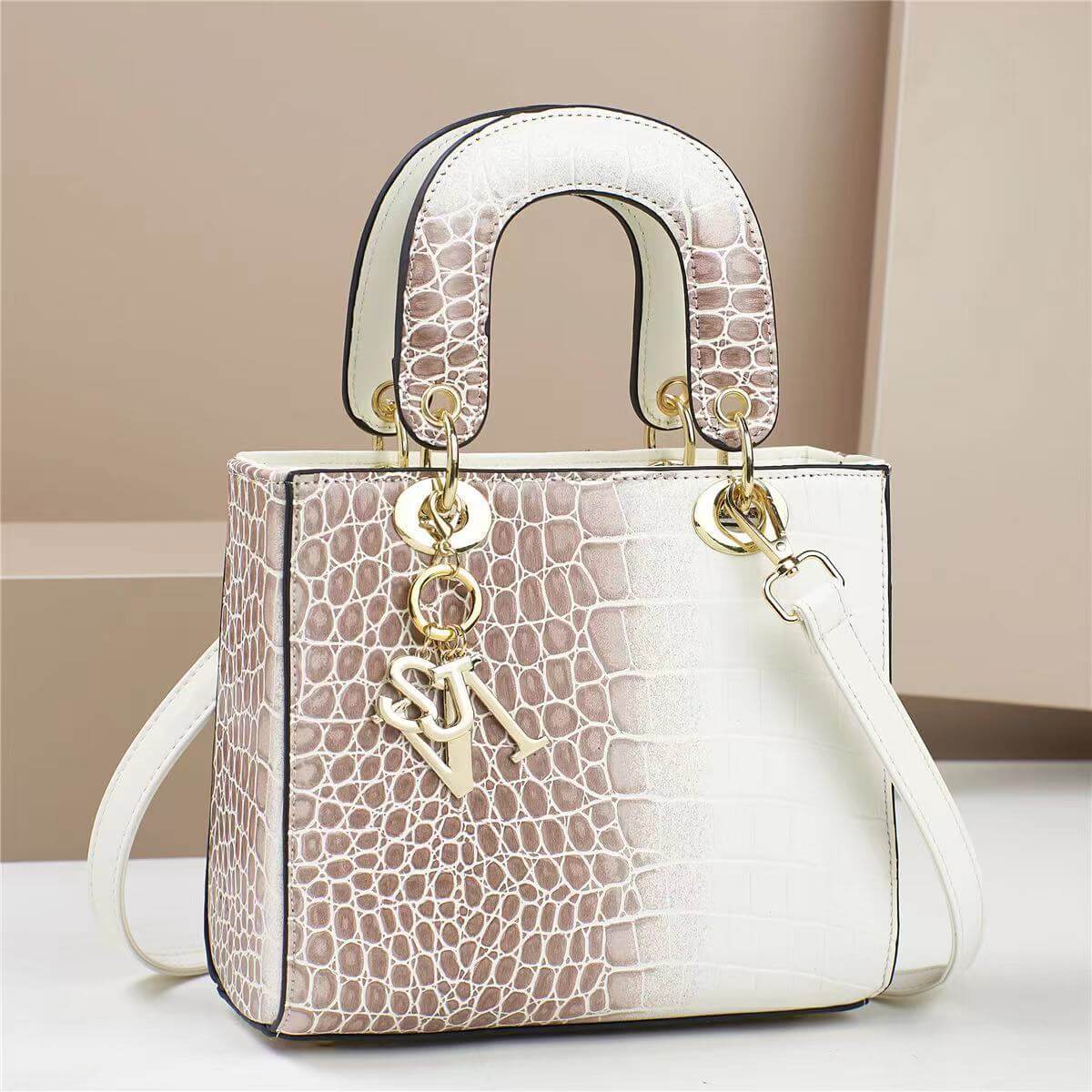 Elegant two-tone handbag with a crocodile pattern design, showcasing golden accents and a chic square shape.