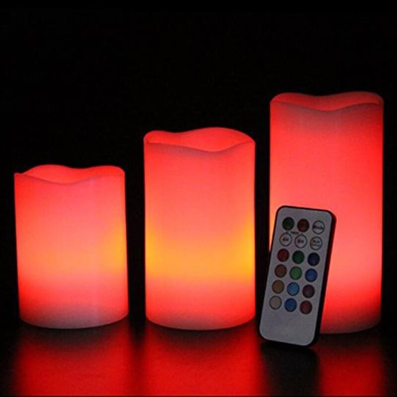 Flameless Candle Stick Candles in various sizes glowing softly in red, alongside a remote control for color options.