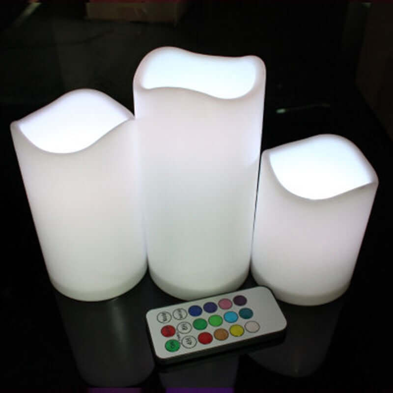 Set of three flameless candle stick candles with remote control, glowing softly to enhance any space.