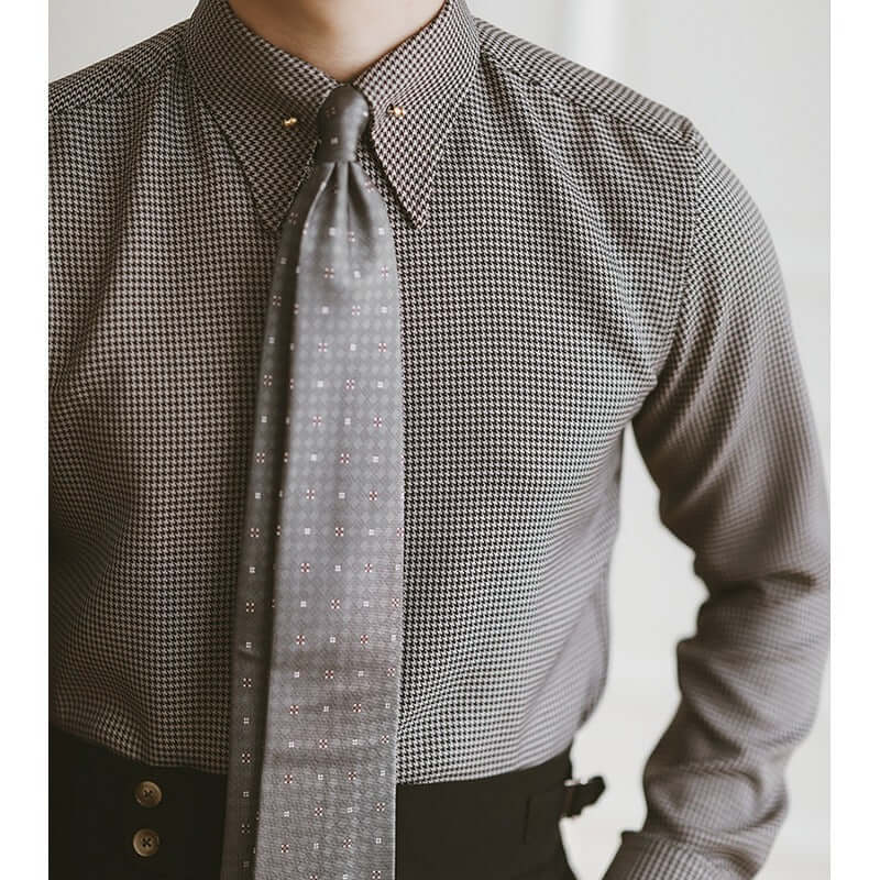 Close-up of a gentleman wearing a stylish plaid fashion shirt with a tie, perfect for elevating any man's wardrobe in taste and sophistication.