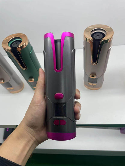 Hand holding a sleek pink and gray Hair Curler Automatic with other color options in the background, showcasing its portable design.