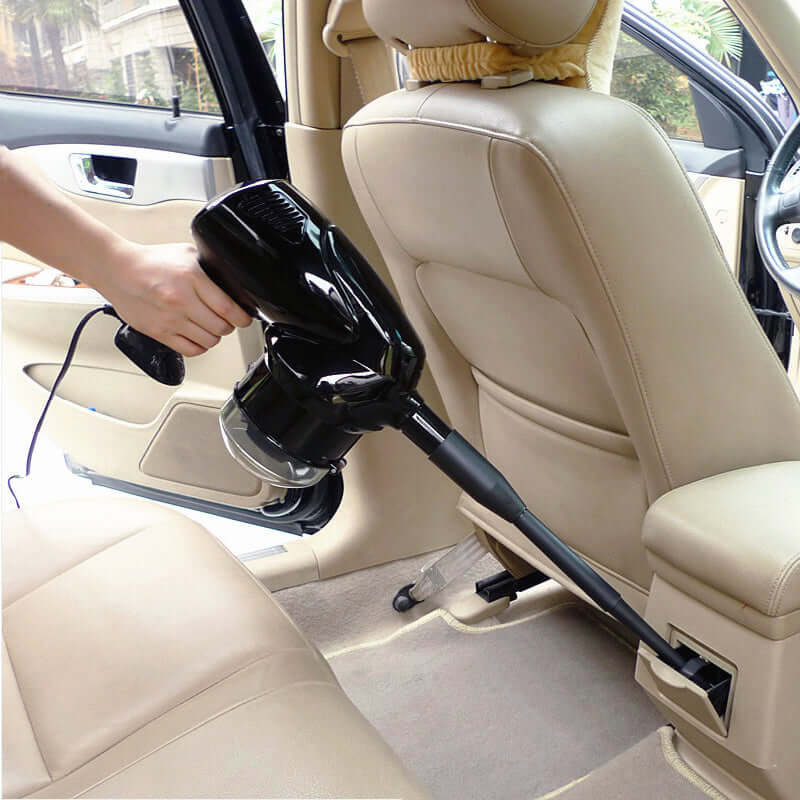 Hand held vacuum cleaner in use inside a car, efficiently cleaning upholstery and hard-to-reach areas.