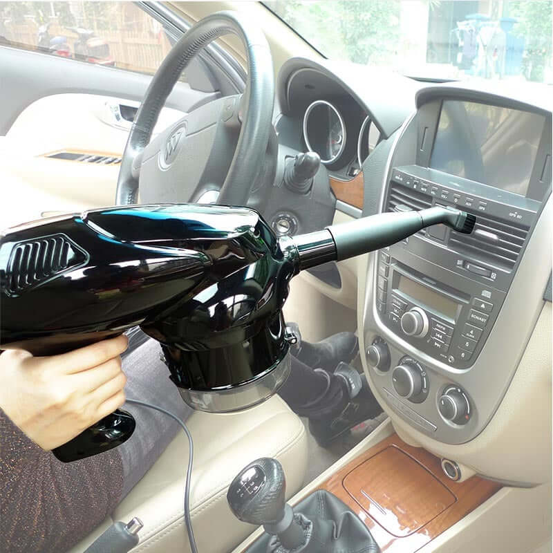 Hand Held Vacuum Cleaner being used inside a car, highlighting its portability and efficiency for quick cleanups.