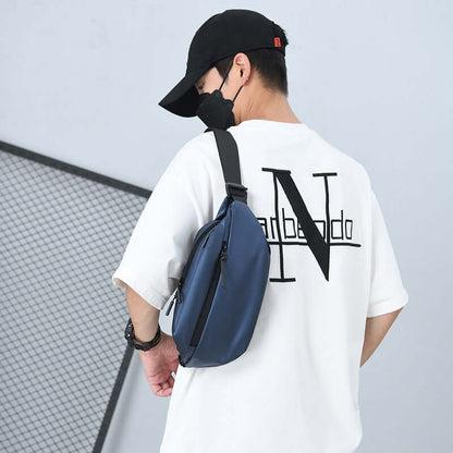 Man wearing a sleek blue high capacity waist bag made of waterproof fabric, designed for active lifestyles.