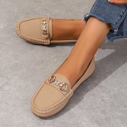 Ladies Comfortable Loafers in khaki, featuring a chic solid design, worn with jeans on a gray floor. Perfect for any occasion.