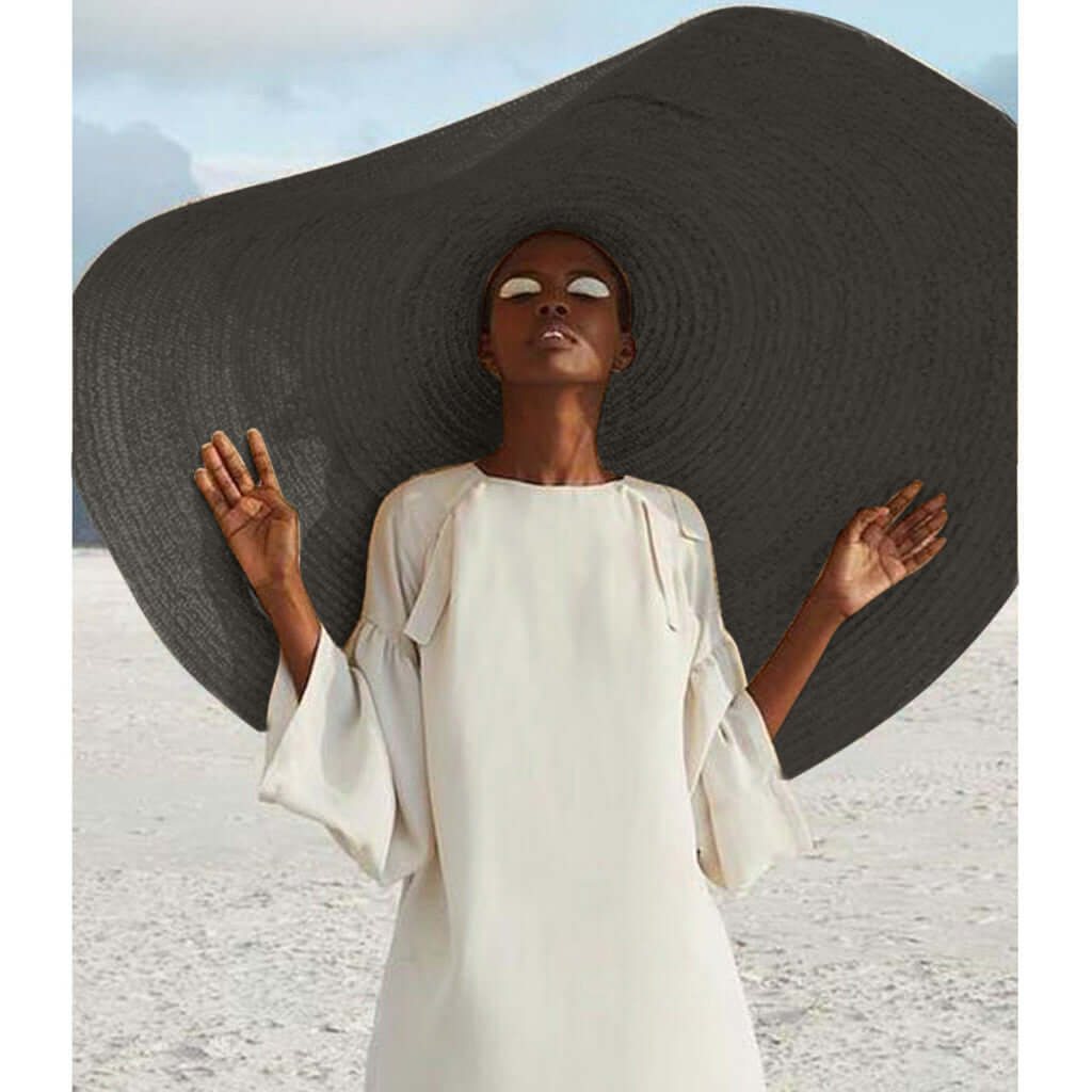 Stylish lady wearing a large straw sun hat and chic white dress, perfect for summer adventures and sun protection.