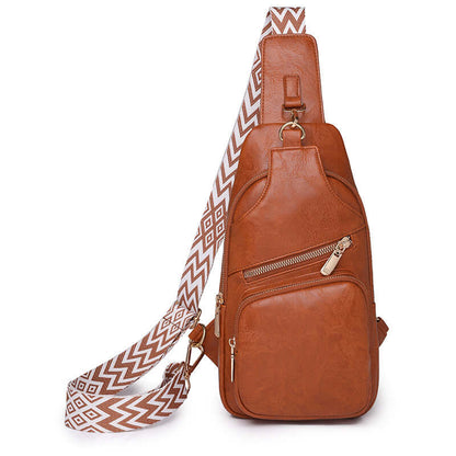 Ladies cross shoulder bag in brown PU leather with patterned strap, showcasing elegant design and functional pockets.