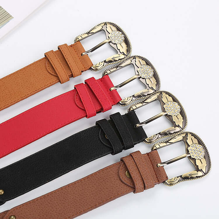 Assortment of Leather Floral Belts in brown, red, black, and tan with ornate metal buckles.