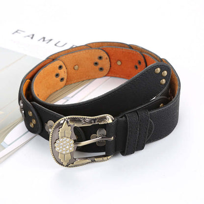 Stylish Black Leather Floral Belt with Decorative Buckle on a Fashion Magazine Background